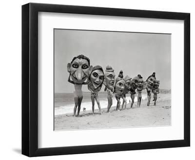 Women Holding Giant Masks - Black Framed Art Print Wall Art, 12x9